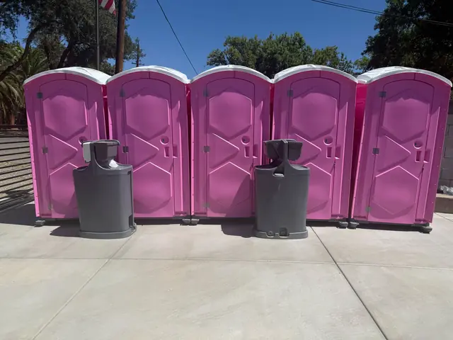 Row of event porta potties with handwashing stations