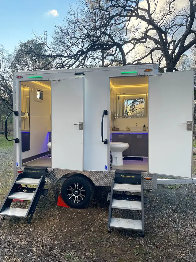 Two-door luxury restroom trailer with lit interiors